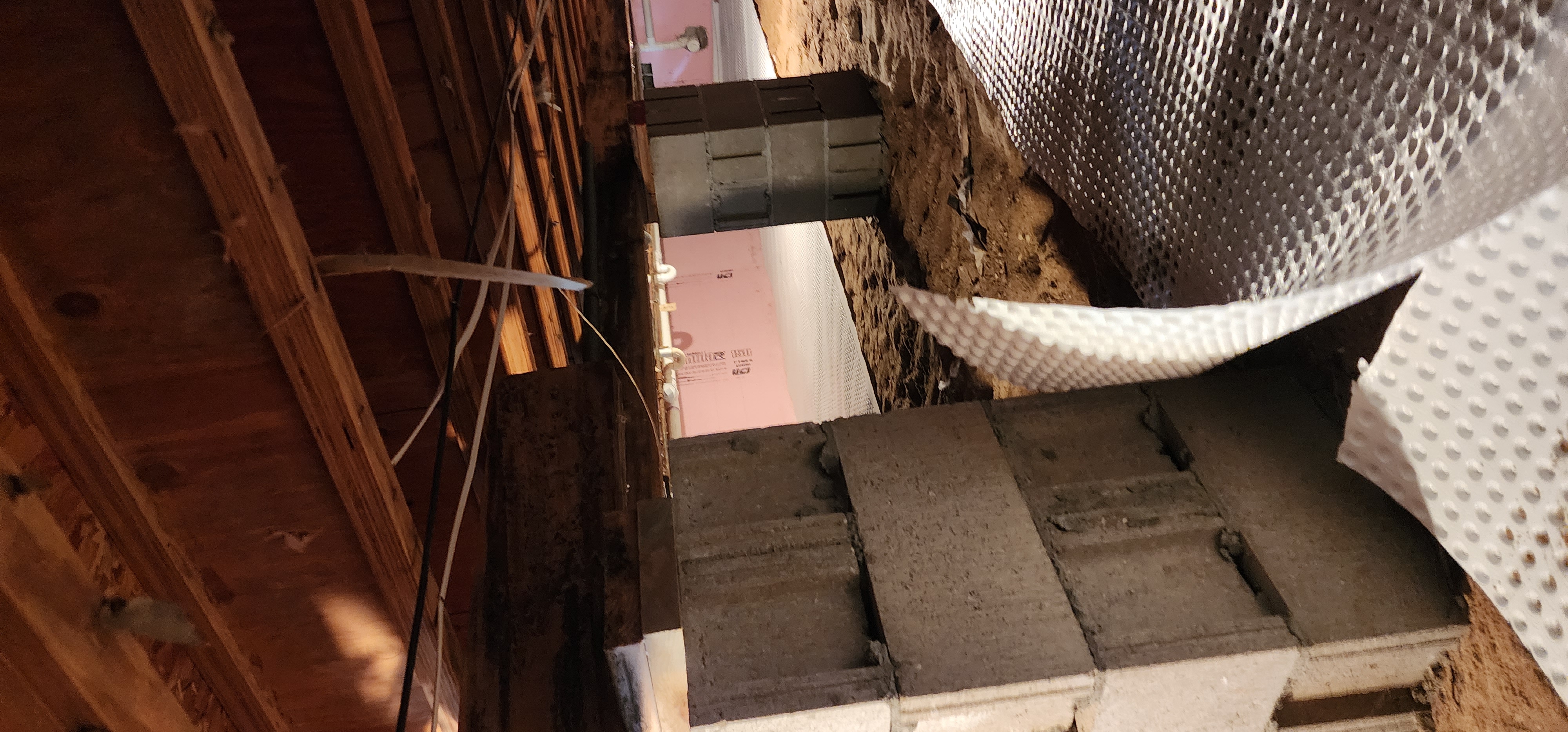 Crawlspace encapsulation process in a home with a view of clean and sealed crawlspace.