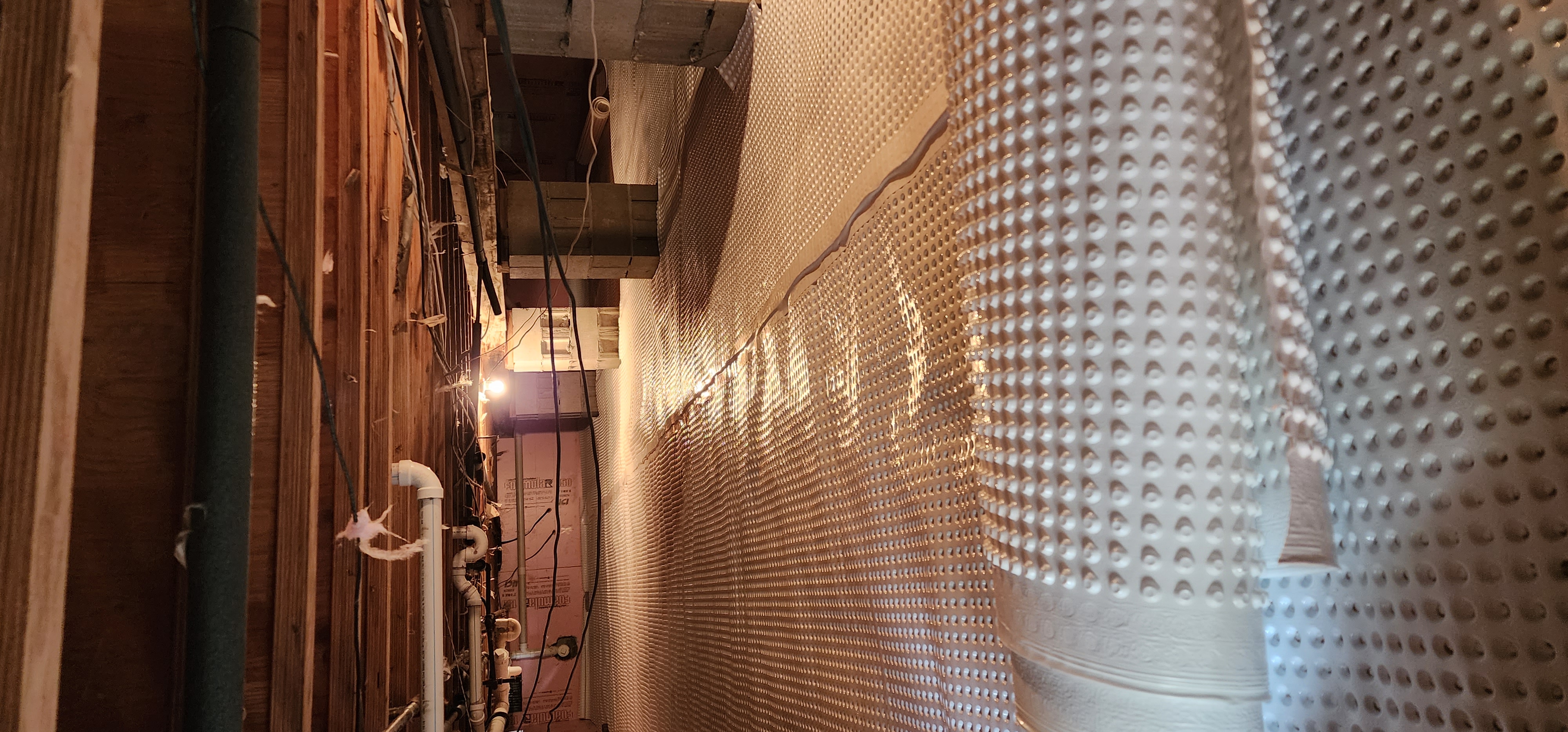 Crawlspace encapsulation process showing sealed and insulated crawlspace in a home.