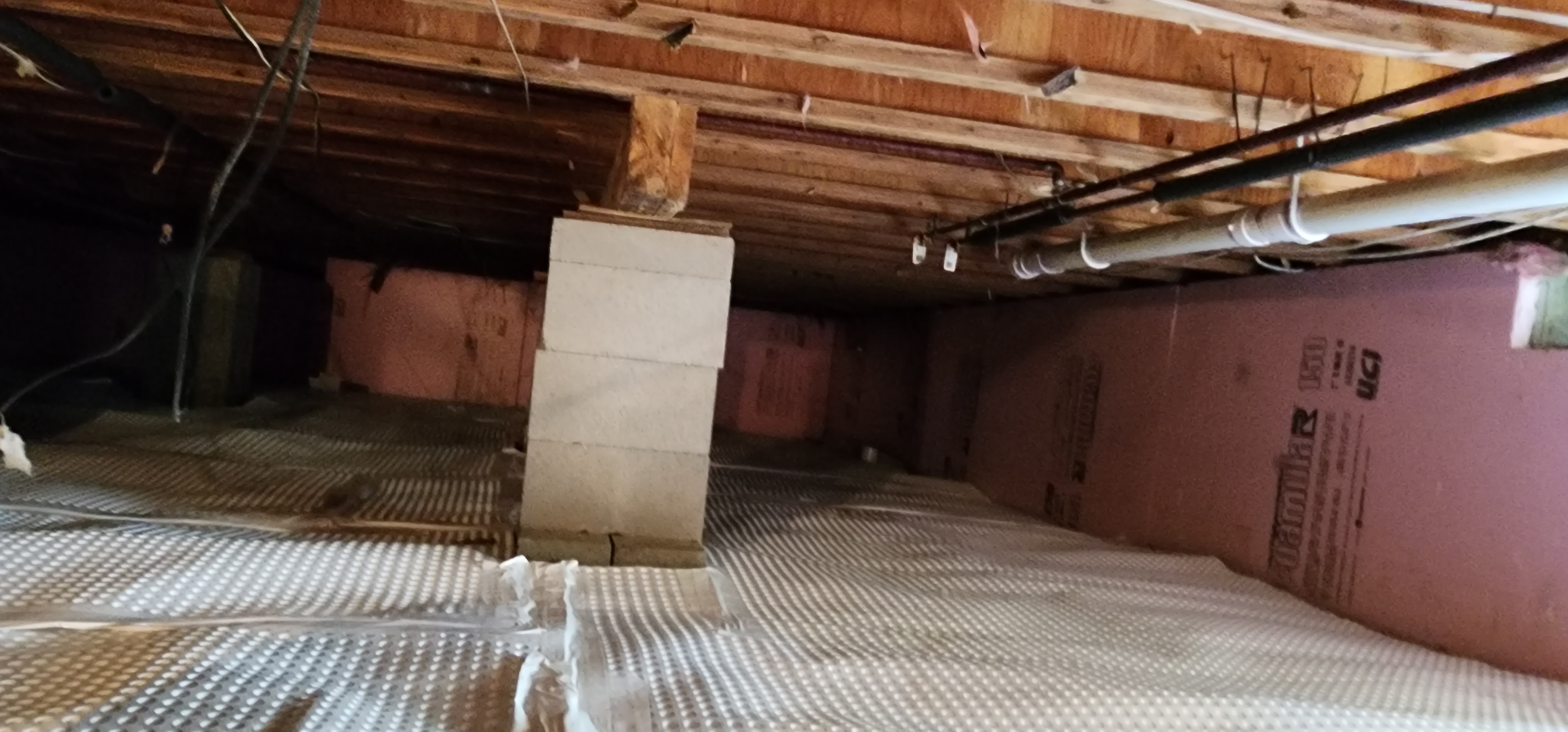 Crawlspace encapsulation process showing sealed and insulated crawlspace in a home.