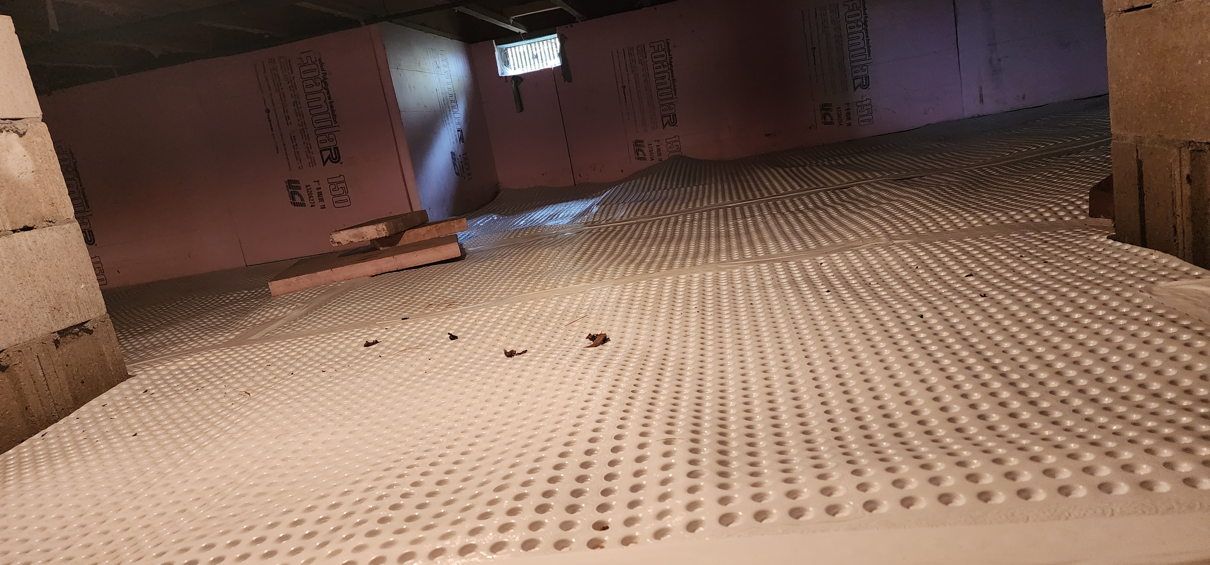 Crawlspace encapsulation process showing sealed and insulated crawlspace in a home.