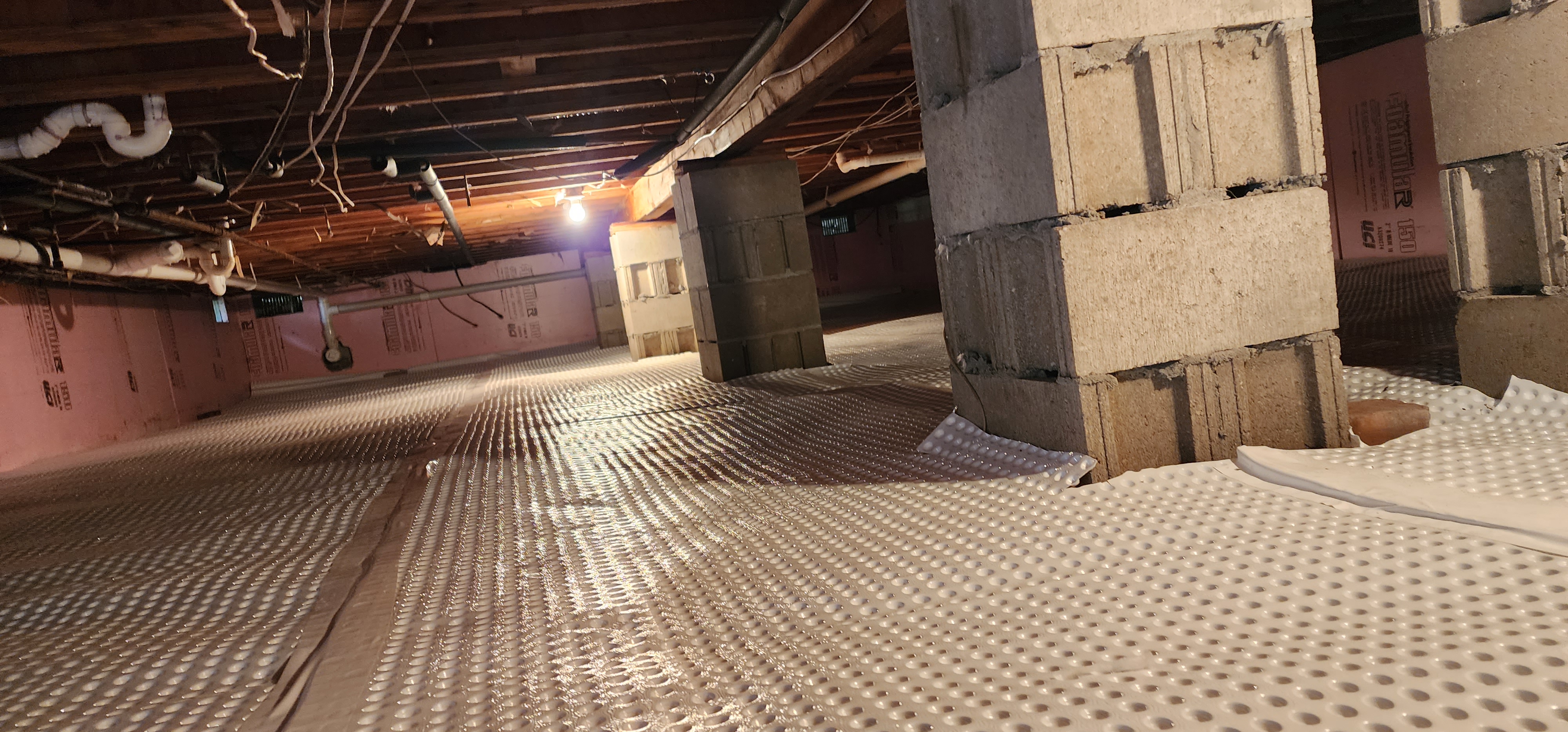 Encapsulated crawlspace in a Benzonia home, highlighting moisture protection and insulation benefits.